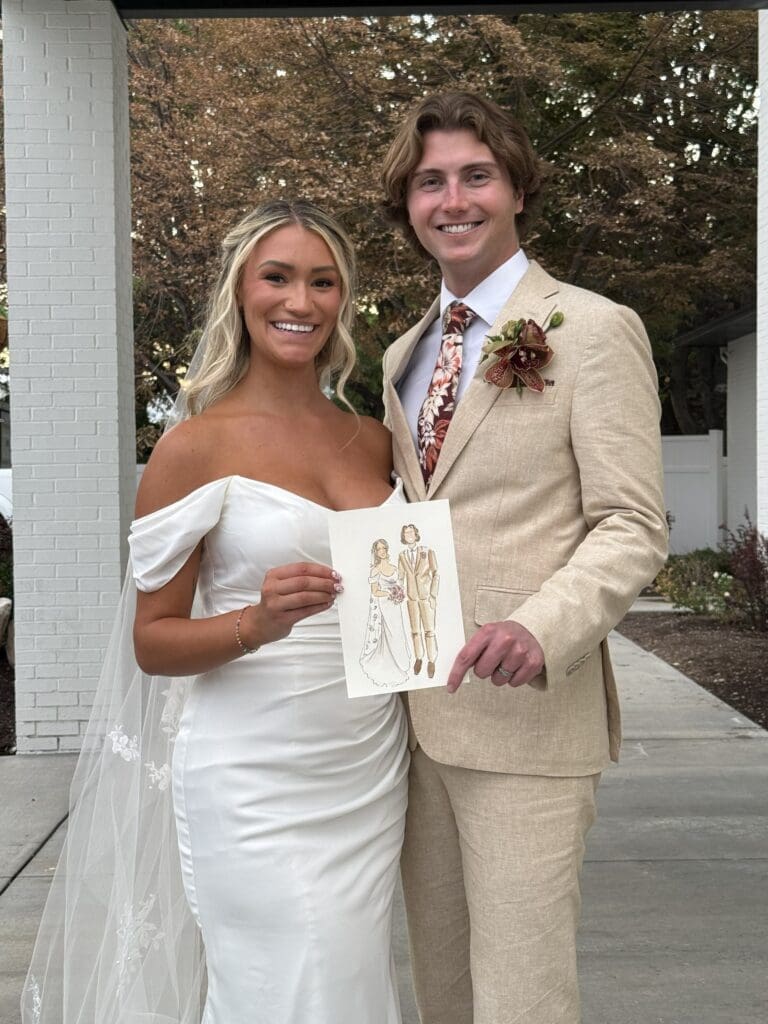 A bride in groom holding their watercolor wedding portrait from Faz Creates Co